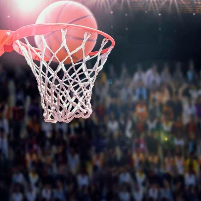 Basketball flying into a basket