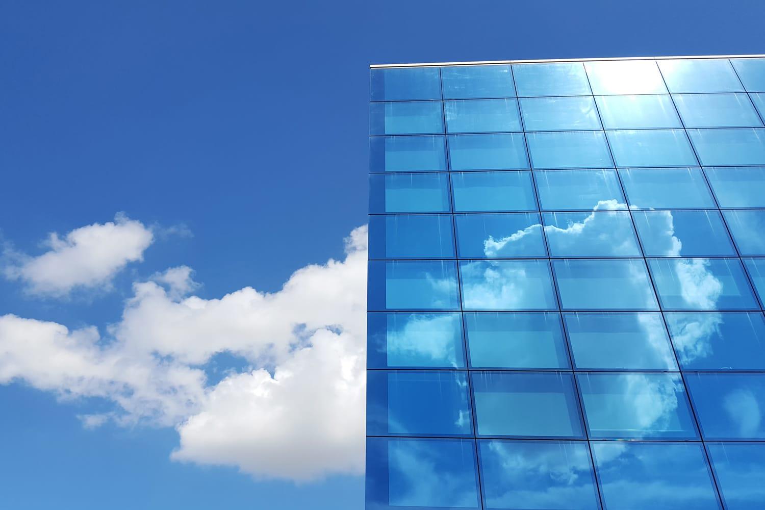 Blue sky with clouds and glass building