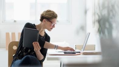 businesswoman using laptop in office, new jersey