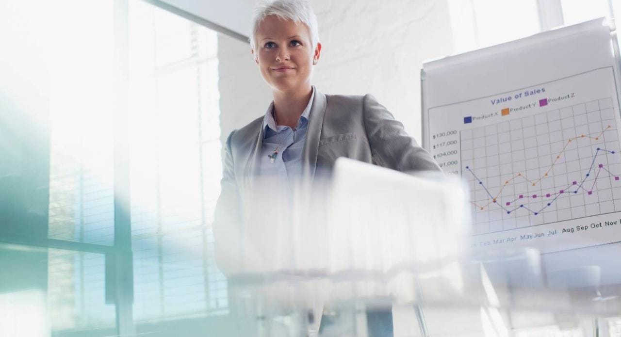 Young confident woman in short white hair in open office