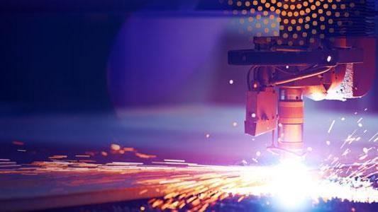 Manufacturing welder with sparks and orange radiance