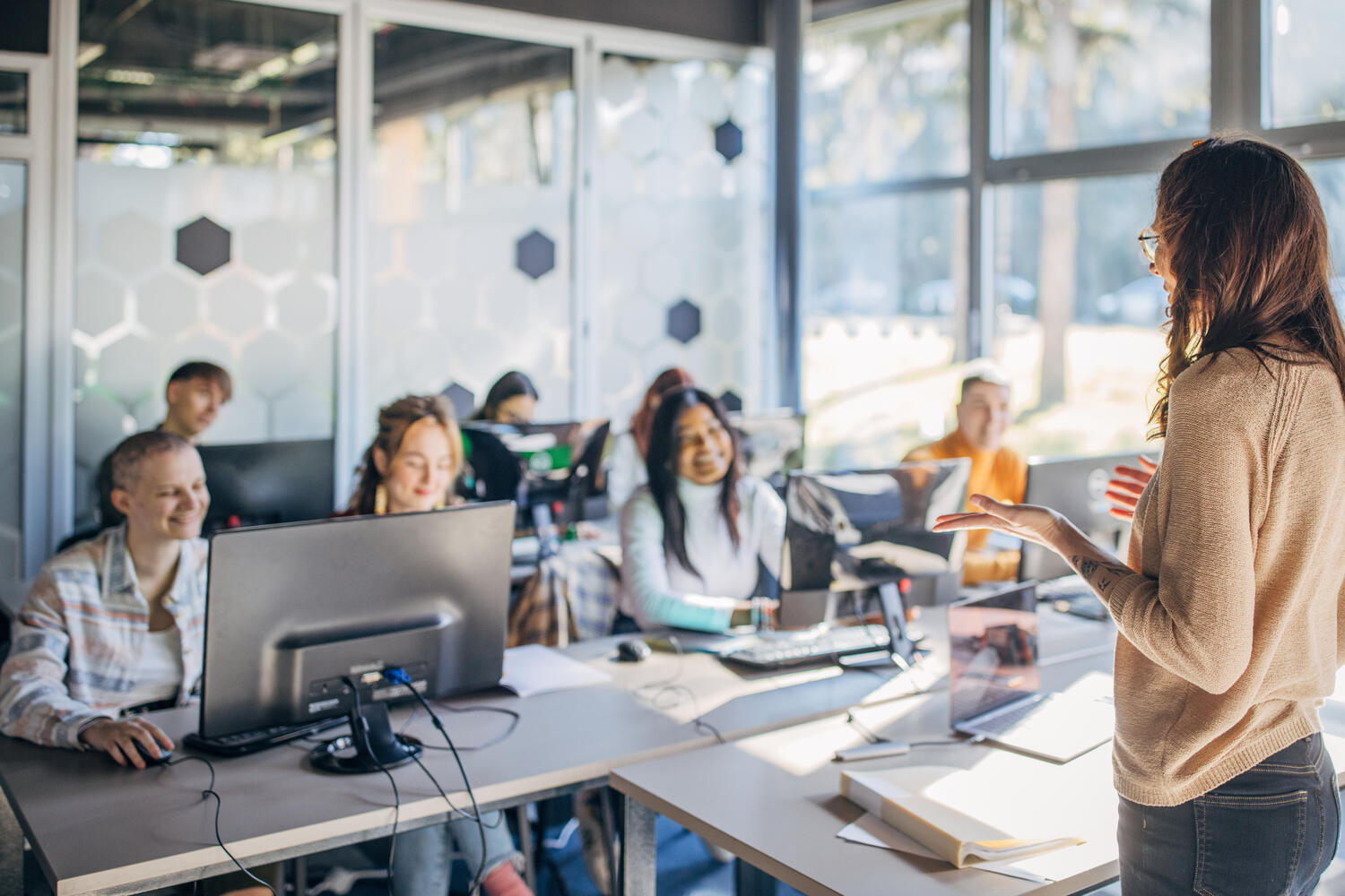 Use and optimize your software Coworkers at a modern office working on a laptop