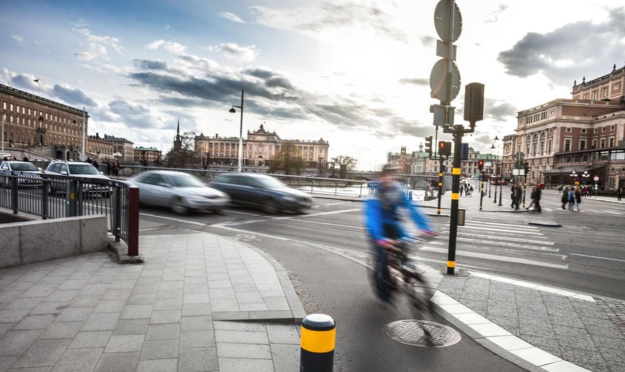 Woman cycling on bike lane in Stockholm downtown