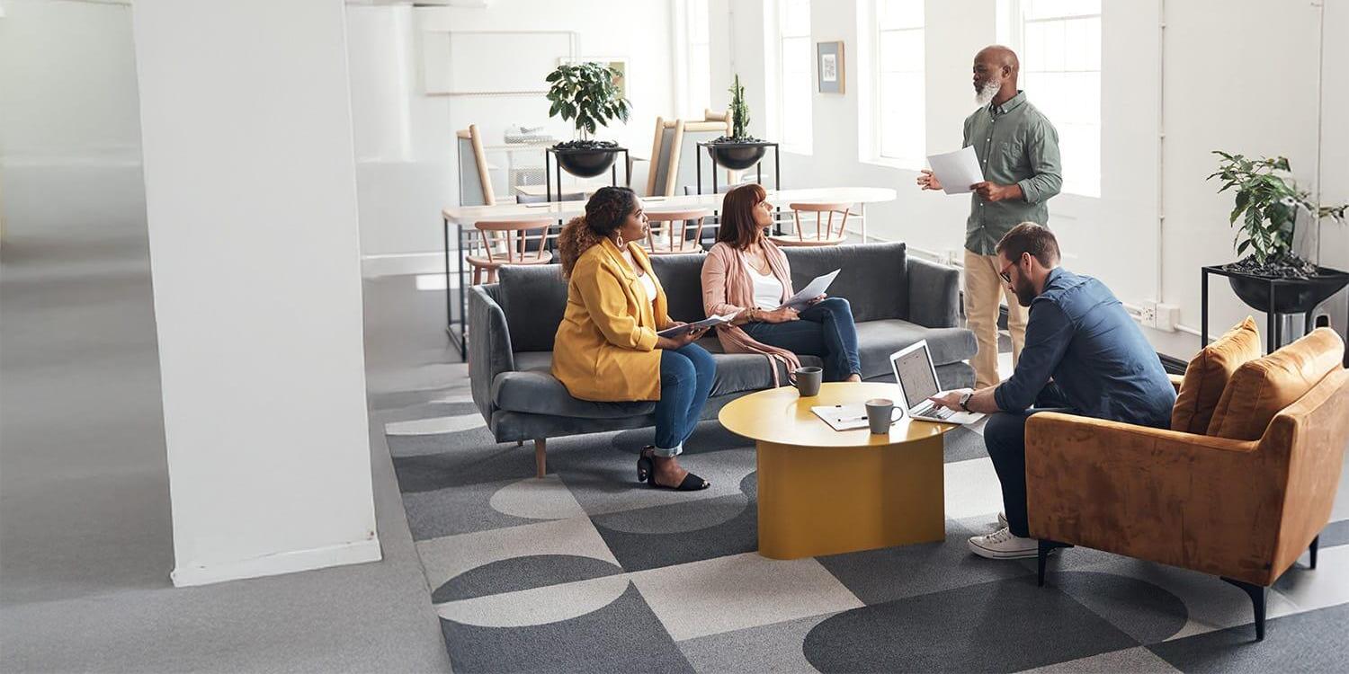 Diverse group of coworkers casually meeting in open office Diverse group of coworkers casually meeting in open office