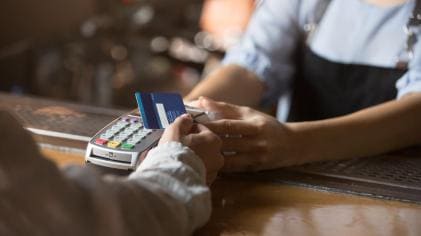 female customer using credit card to pay electronically