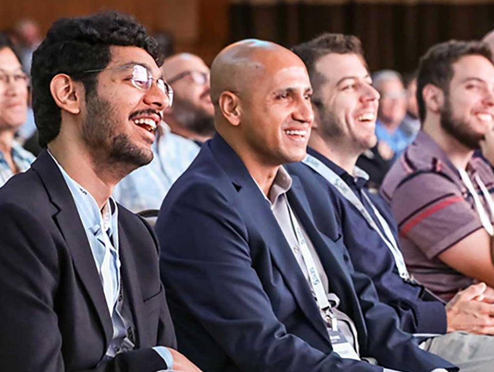 Group of people sitting and smiling while attending SAS Innovate