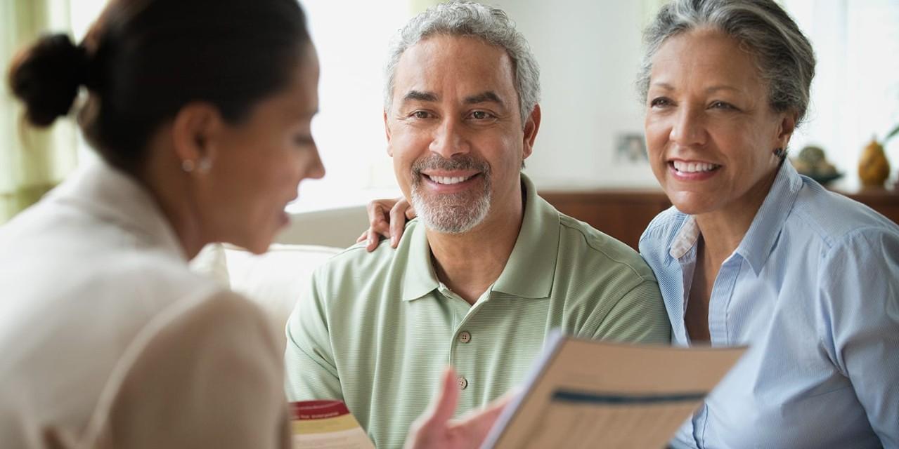 Businesswoman talking to clients in living room