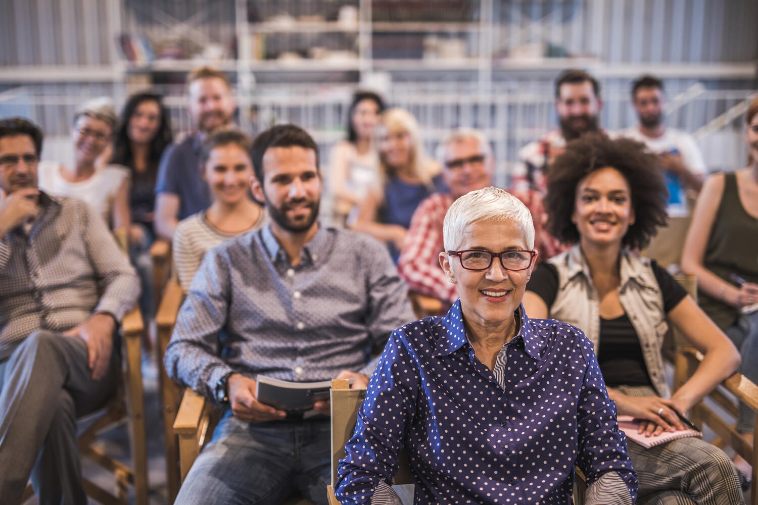 Man leaning back in desk chair looking at computer screen