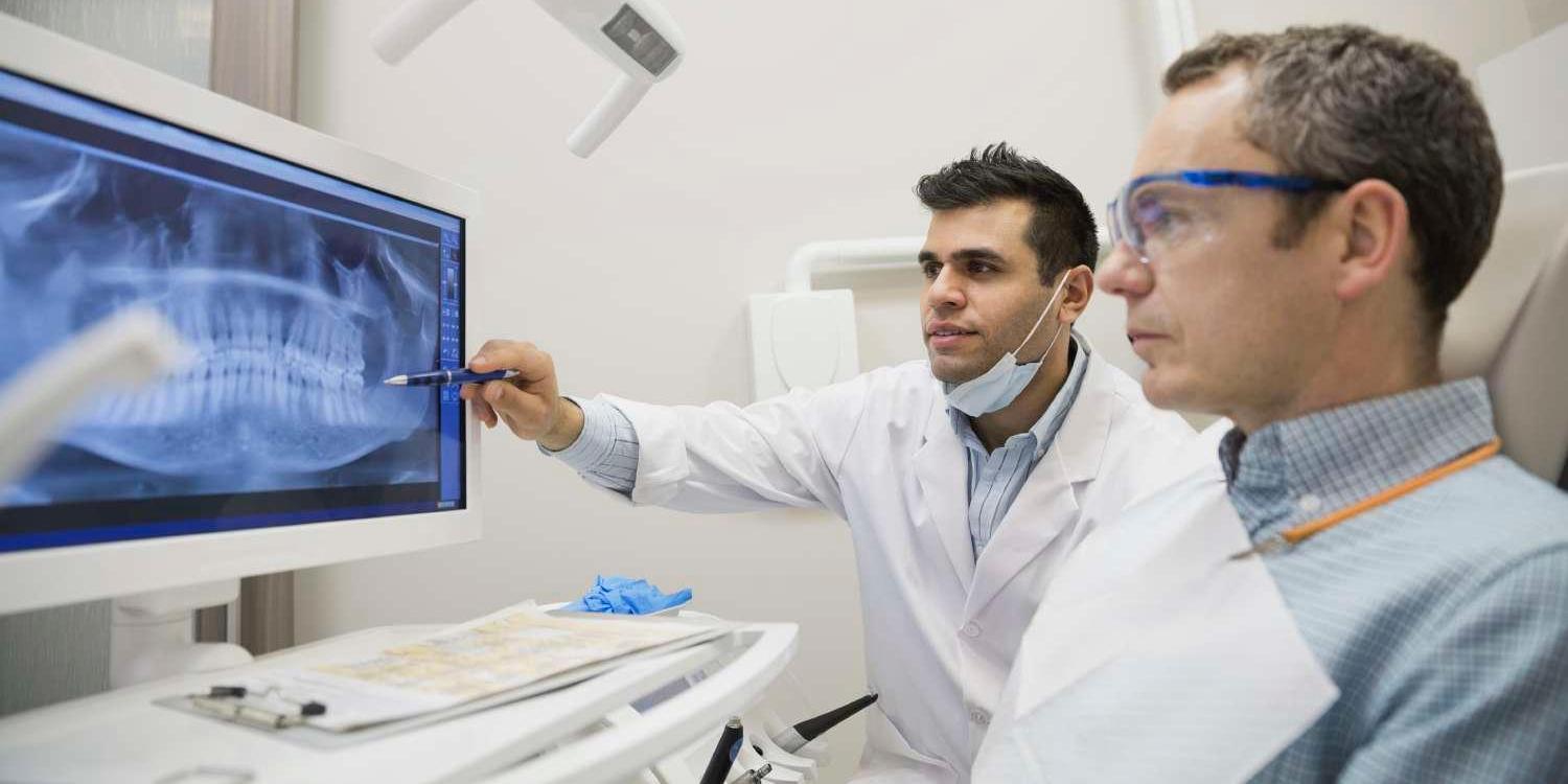 Dentist showing x-rays to patient