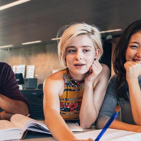 College students working together on a shared laptop