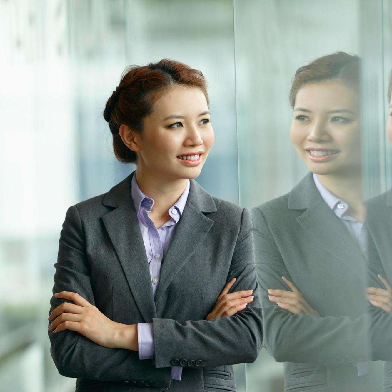 Business woman looking at her reflection 
