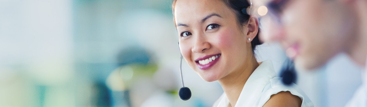 Young asian business woman on headset at call center
